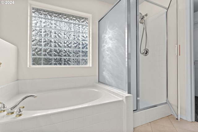 bathroom with separate shower and tub and tile patterned flooring