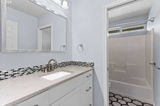 full bathroom featuring shower / bathing tub combination, decorative backsplash, toilet, and vanity