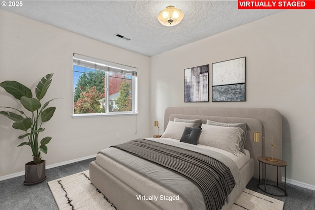 carpeted bedroom featuring a textured ceiling