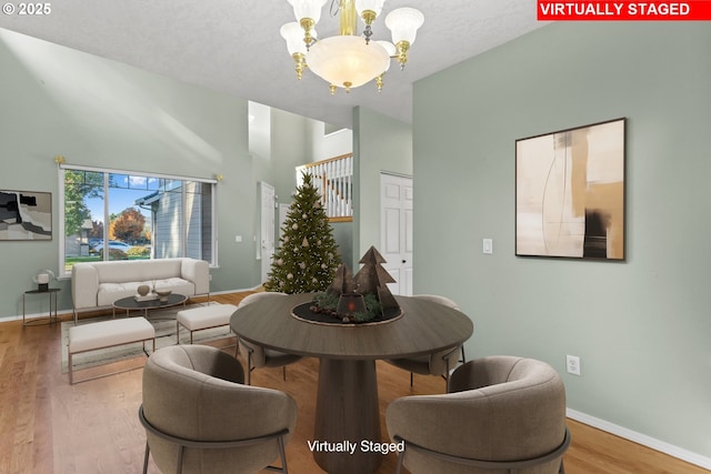 dining room featuring hardwood / wood-style flooring and an inviting chandelier