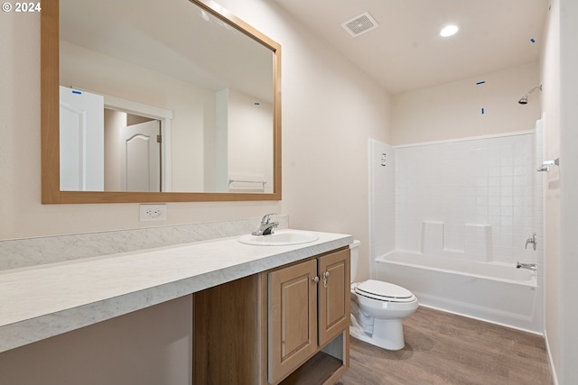 full bathroom with bathing tub / shower combination, hardwood / wood-style floors, vanity, and toilet