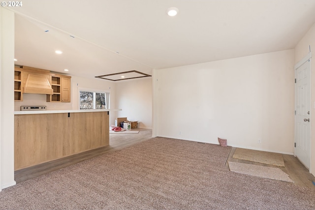 unfurnished living room featuring light carpet