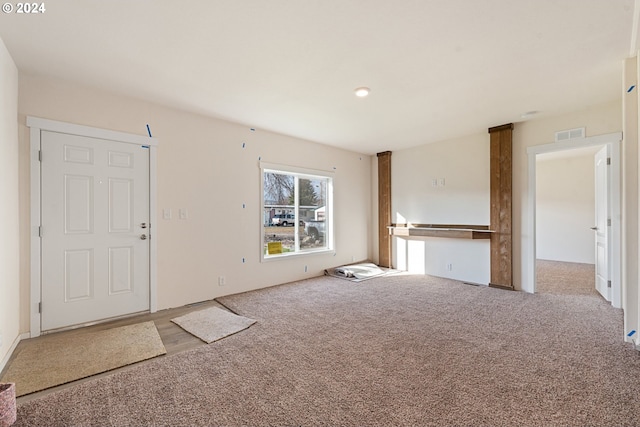 unfurnished living room with light carpet