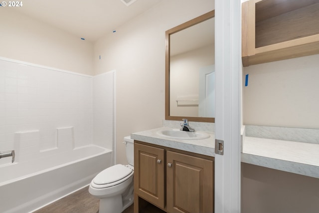 full bathroom featuring bathtub / shower combination, vanity, hardwood / wood-style flooring, and toilet