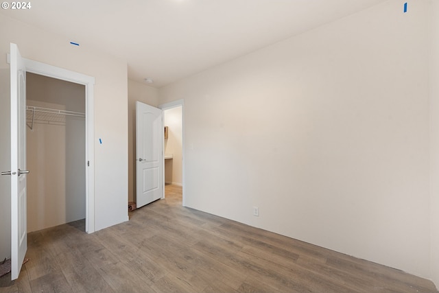 unfurnished bedroom featuring a closet and light hardwood / wood-style flooring