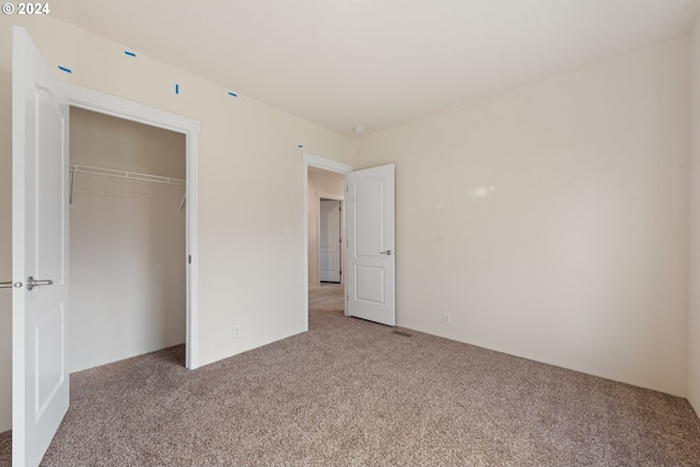 unfurnished bedroom featuring a closet and carpet floors