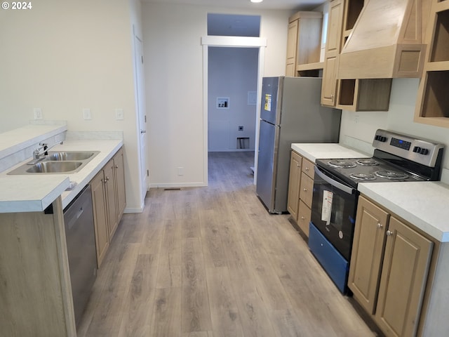 kitchen featuring premium range hood, sink, light hardwood / wood-style flooring, light brown cabinetry, and appliances with stainless steel finishes