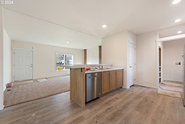 kitchen with hardwood / wood-style floors, dishwasher, and sink