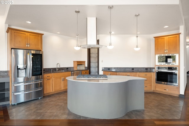 kitchen with kitchen peninsula, appliances with stainless steel finishes, decorative light fixtures, sink, and island range hood