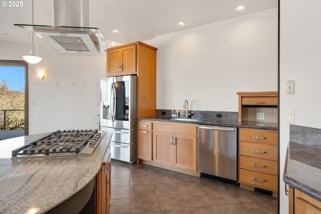 kitchen featuring appliances with stainless steel finishes, dark tile patterned flooring, sink, decorative light fixtures, and dark stone countertops