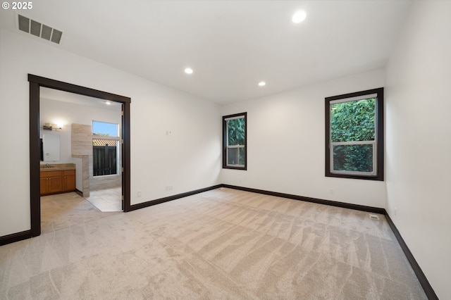 empty room featuring light carpet