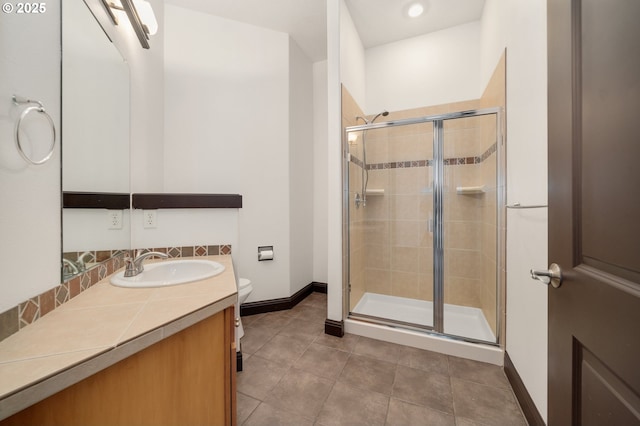 bathroom featuring toilet, an enclosed shower, and vanity