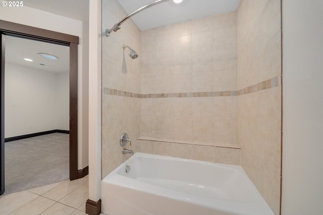 bathroom featuring tiled shower / bath and tile patterned flooring