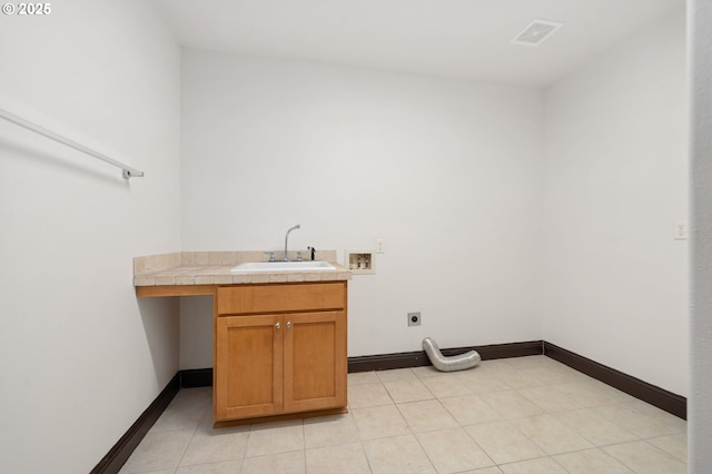 washroom featuring sink, hookup for an electric dryer, cabinets, and washer hookup