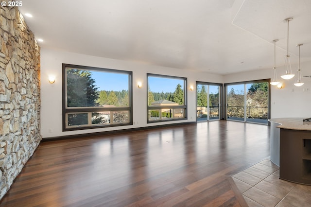 unfurnished living room featuring dark hardwood / wood-style flooring