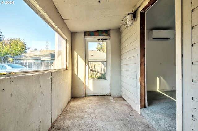 interior space with vaulted ceiling and a wall mounted air conditioner