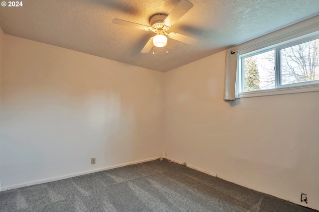 carpeted spare room with a textured ceiling and ceiling fan