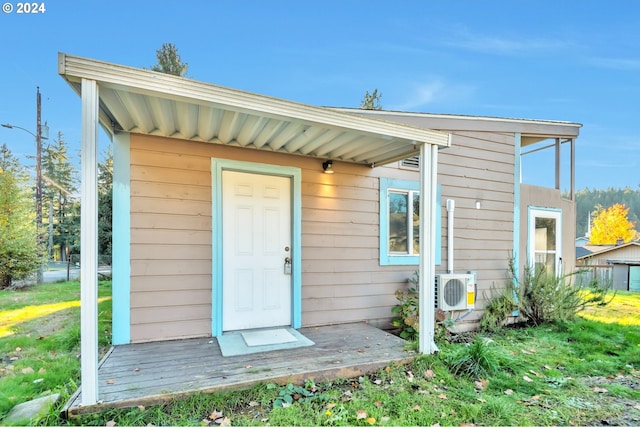 exterior space with ac unit and a yard