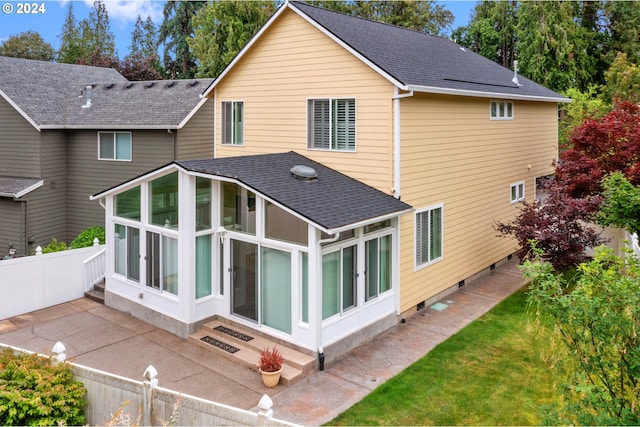 back of property featuring a sunroom and a patio