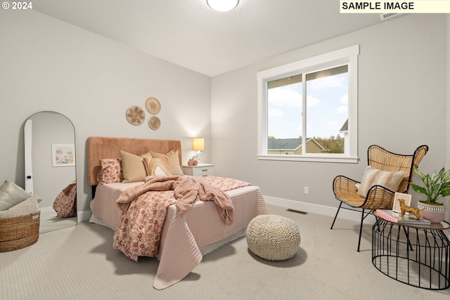 bedroom featuring light carpet