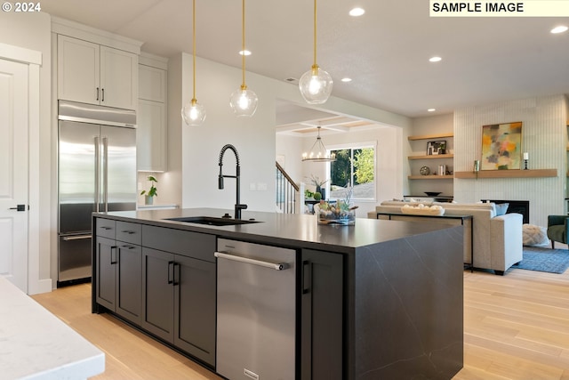 kitchen with light hardwood / wood-style floors, white cabinetry, sink, and appliances with stainless steel finishes