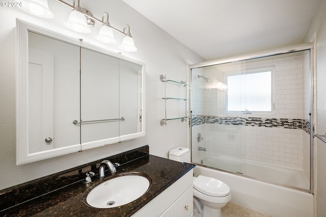 full bathroom with vanity, tile patterned flooring, shower / bath combination with glass door, and toilet