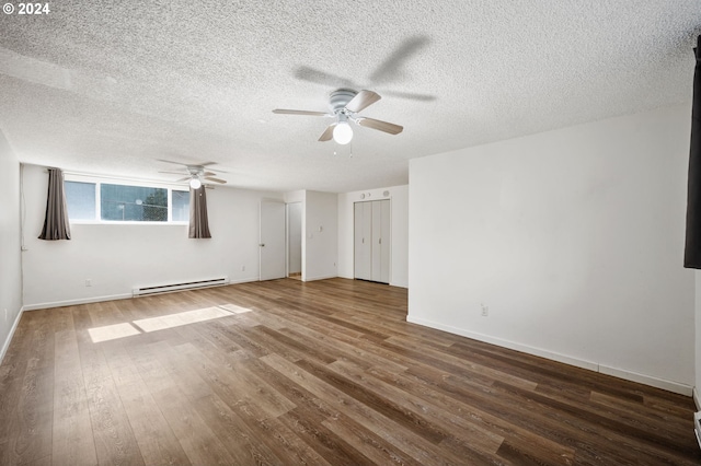 empty room with ceiling fan, a baseboard heating unit, hardwood / wood-style floors, and a textured ceiling