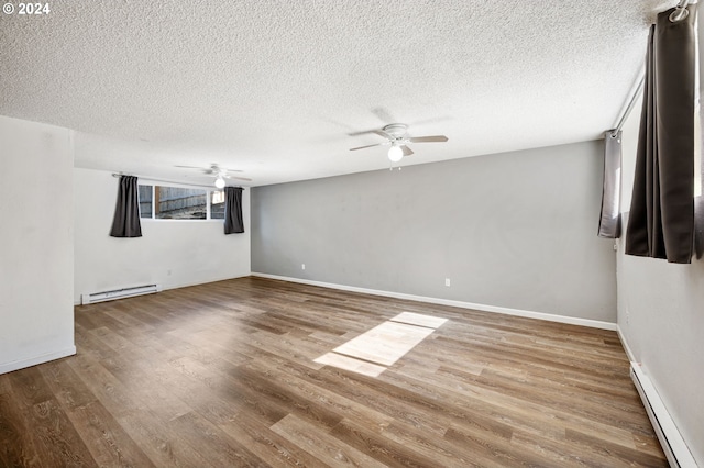 interior space featuring a textured ceiling, a baseboard heating unit, and wood-type flooring