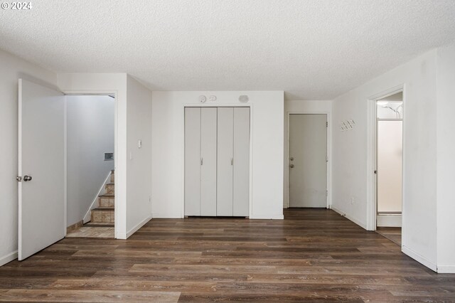 unfurnished bedroom with a textured ceiling and hardwood / wood-style flooring