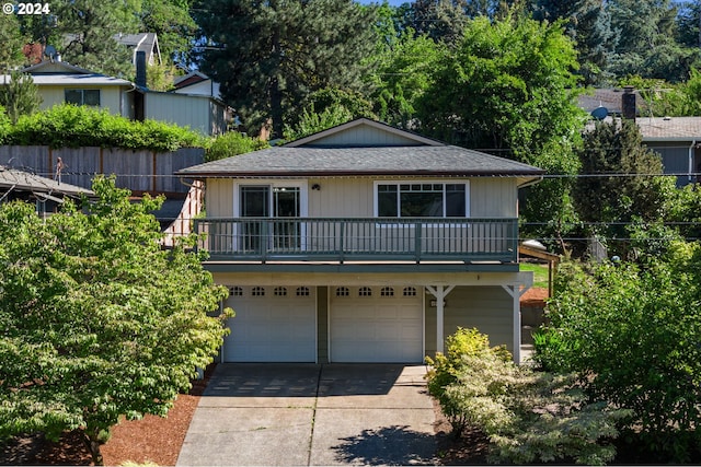 view of property featuring a garage and a balcony