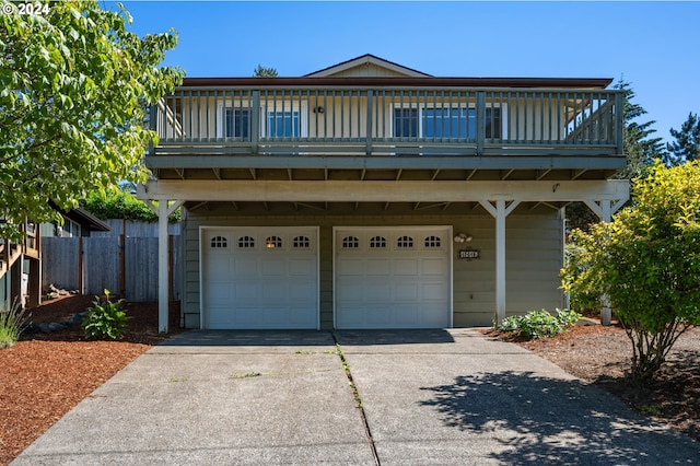 view of property featuring a balcony and a garage