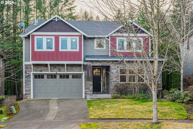 craftsman inspired home with a front yard and a garage