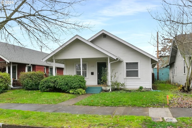 bungalow-style house with a front lawn