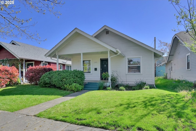 view of front of property with covered porch and a front yard
