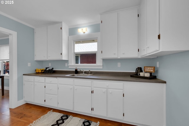 kitchen with dark countertops and white cabinetry