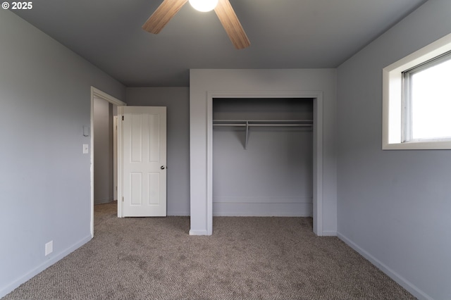 unfurnished bedroom with a closet, light colored carpet, and ceiling fan