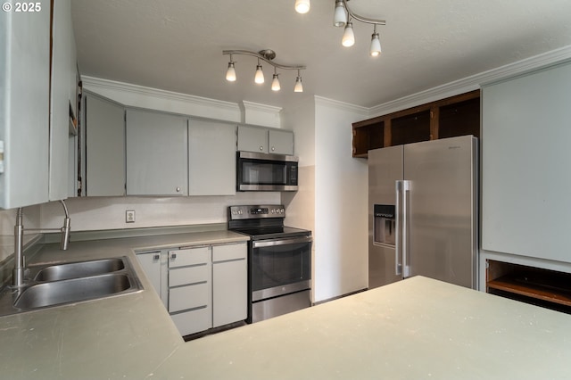 kitchen with stainless steel appliances, ornamental molding, and sink