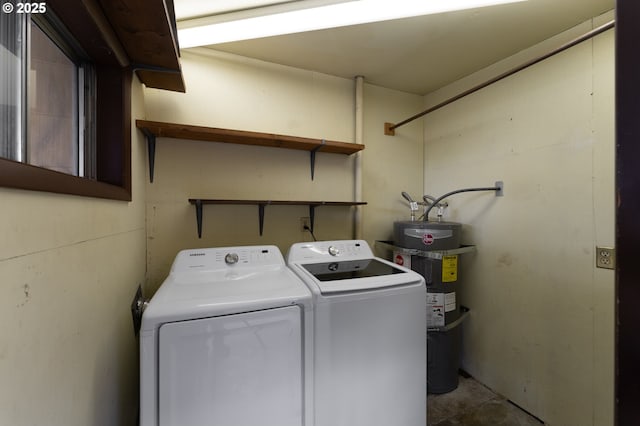 clothes washing area with secured water heater and washer and dryer