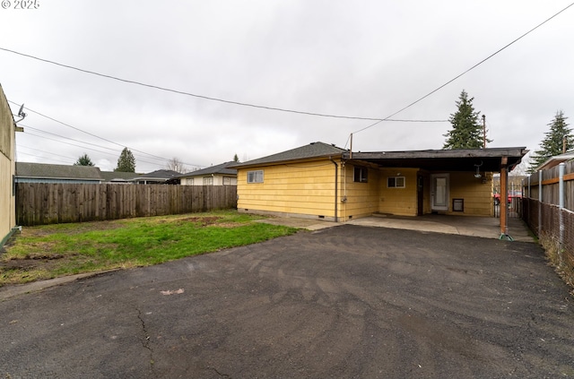 exterior space featuring a carport and a front lawn