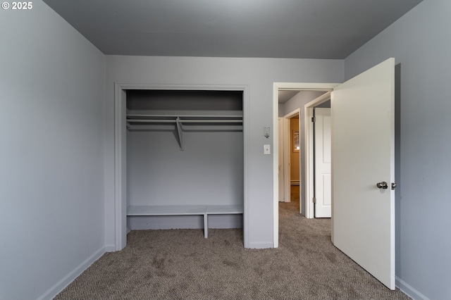 unfurnished bedroom with carpet flooring and a closet