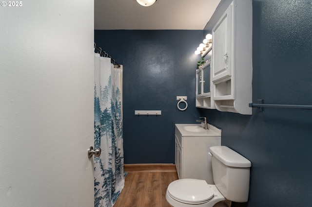 bathroom featuring hardwood / wood-style floors, vanity, and toilet