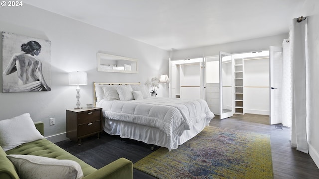 bedroom with baseboards and dark wood finished floors