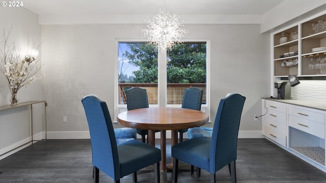 dining room with dark wood-style floors, a notable chandelier, and baseboards