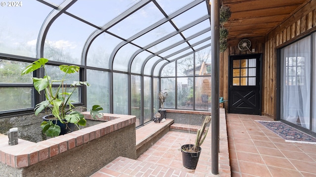 sunroom featuring lofted ceiling