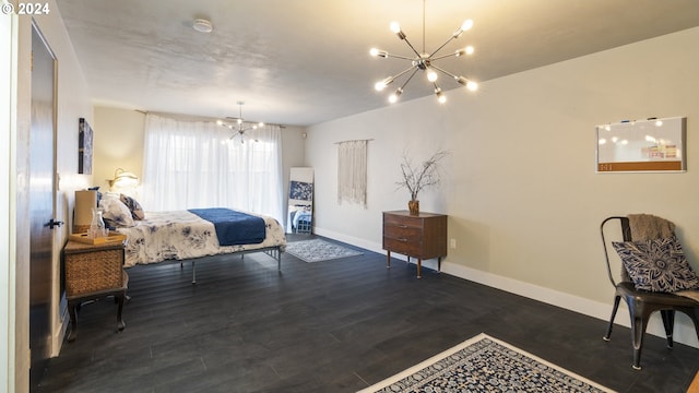 bedroom with baseboards, a notable chandelier, and wood finished floors