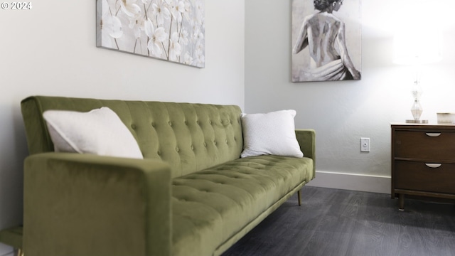 living area with baseboards and wood finished floors