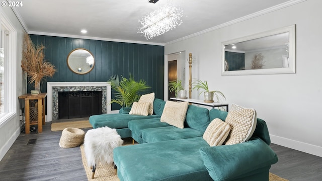 living area featuring visible vents, baseboards, wood finished floors, crown molding, and a fireplace