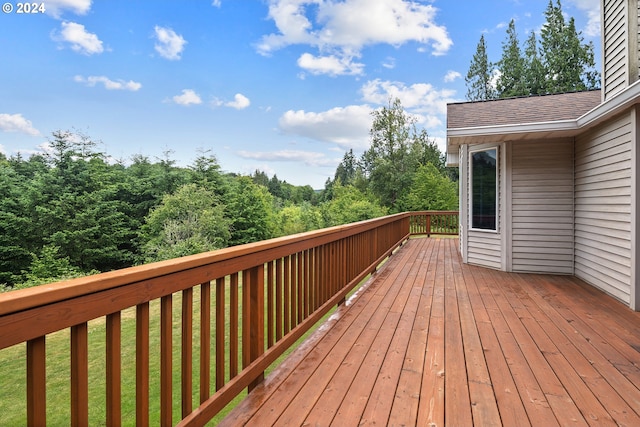 wooden deck featuring a yard