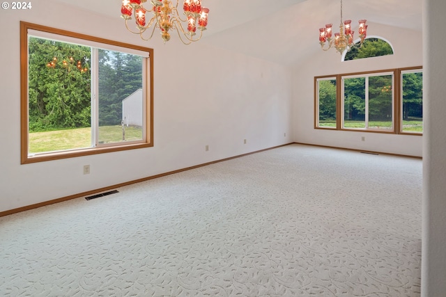 carpeted spare room featuring lofted ceiling and a notable chandelier