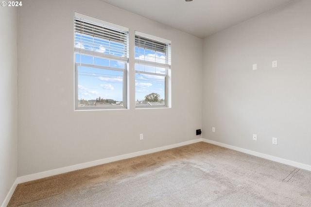 unfurnished room with light carpet